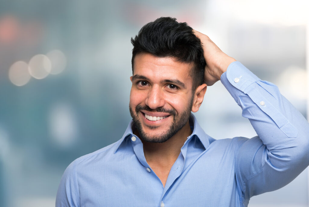 Hair Transplant NYC - Man touching his hair